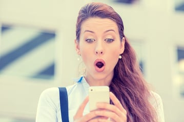 lady surprised looking at phone